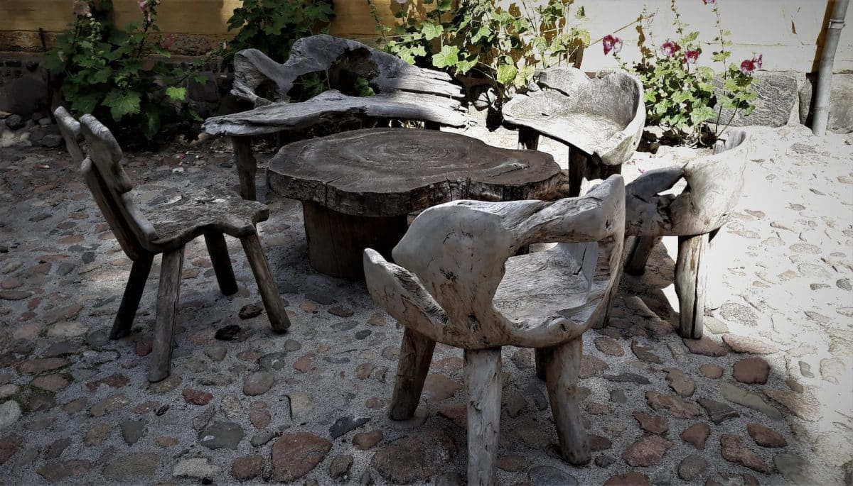 a table and chairs made out of tree stumps