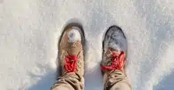 person wearing brown pants and white and red sneakers